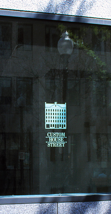 The logo glazed onto an outdoor window.