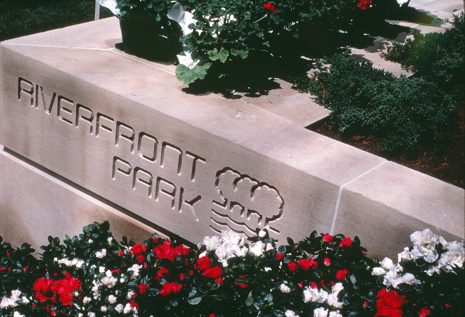 The logo and typace cut into a stone wall at Riverfront Park.