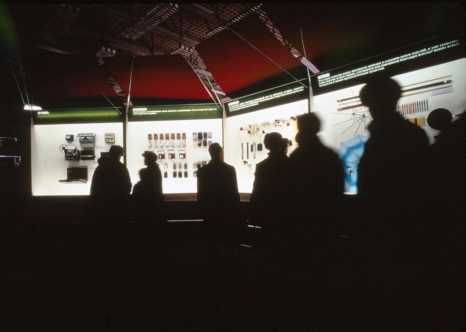 Shadows of people viewing the lighted exhibit.