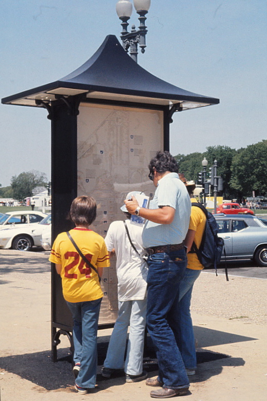 Family looking at kiosk